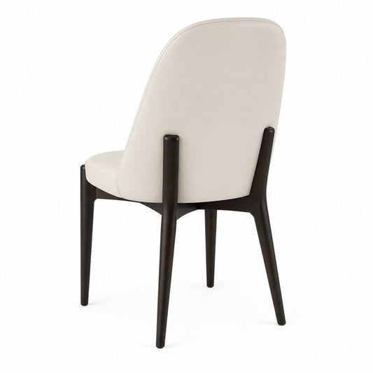 Rear three-quarter view of the Liam dining chair in Aspen PU leather with dark walnut wood frame on a white background.