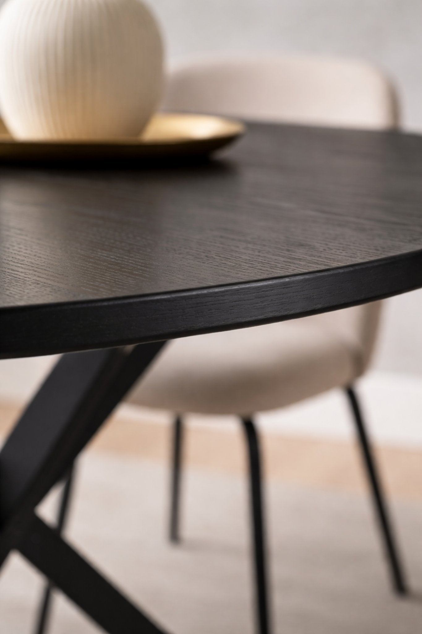 Olen round dining table black wood top close-up showing smooth beveled edge and matte finish
