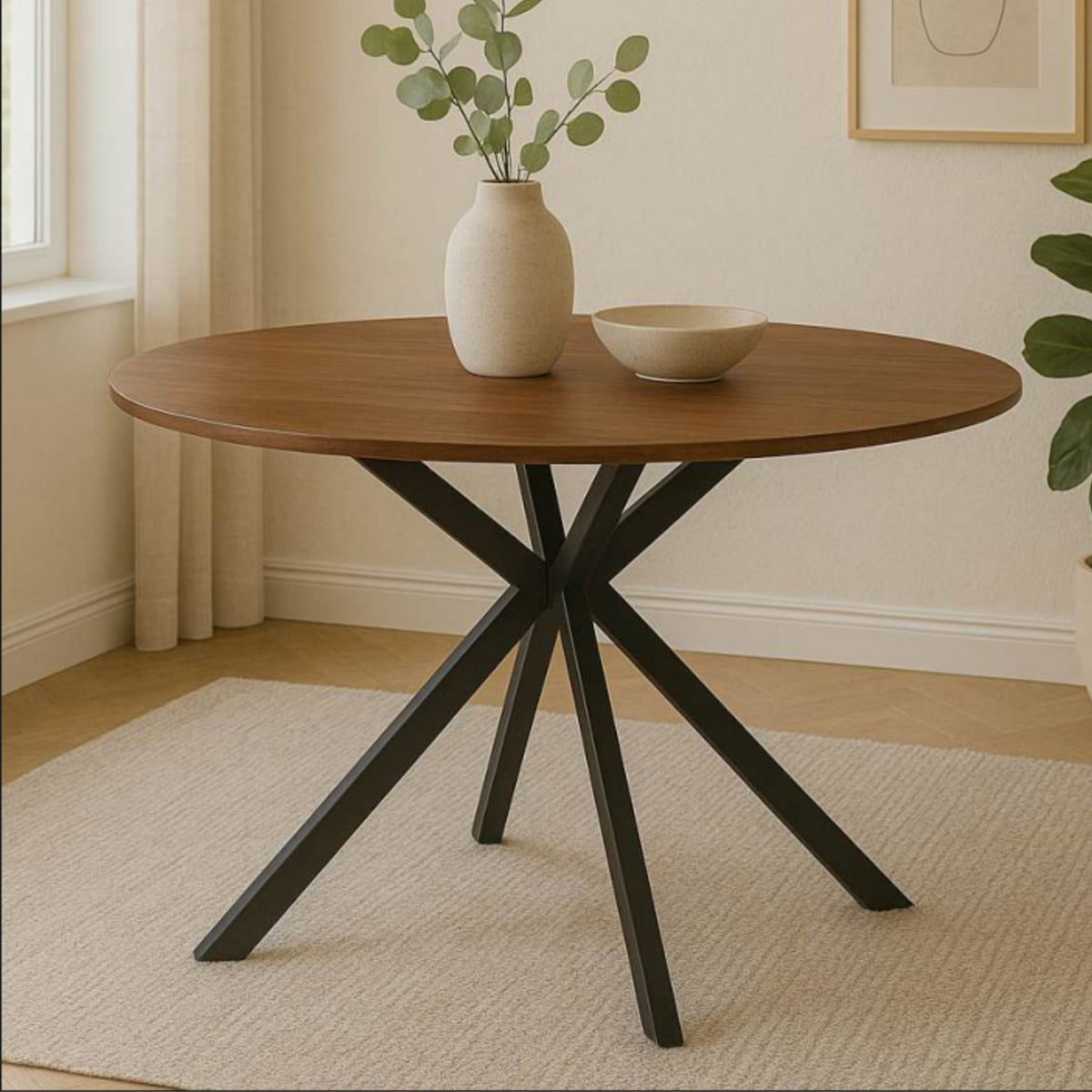 Ivanna walnut round dining table with black metal pedestal base styled in a bright modern dining space