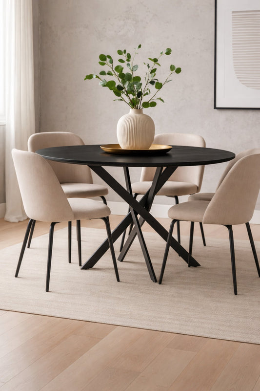 Olen round black dining table styled in a modern dining room with upholstered chairs